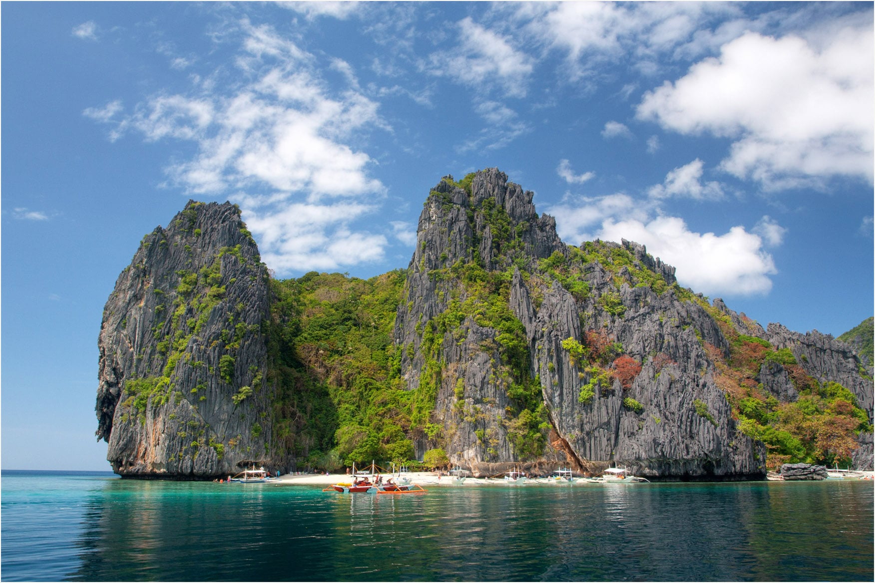 towering cliffs and crystal clear waters in Shimizu Island El Nido Palawan Philippines