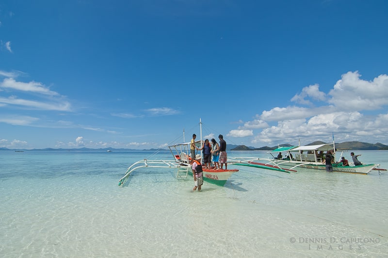 boats on the shoreline of Banul Beach in Coron Palawan Philippines