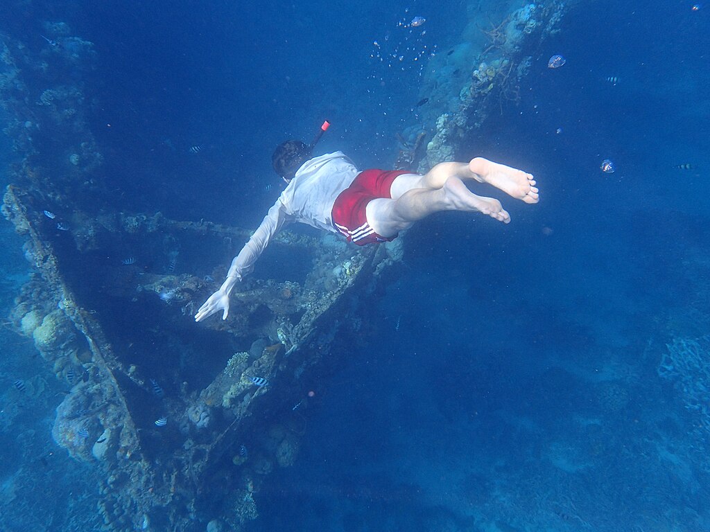 man diving in Skeleton Wreck Coron Palawan Philippines