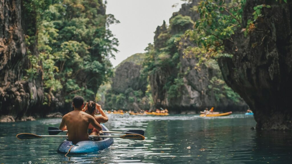 Tourists are kayaking in a small lagoon in El Nido, Palawan, Philippines.