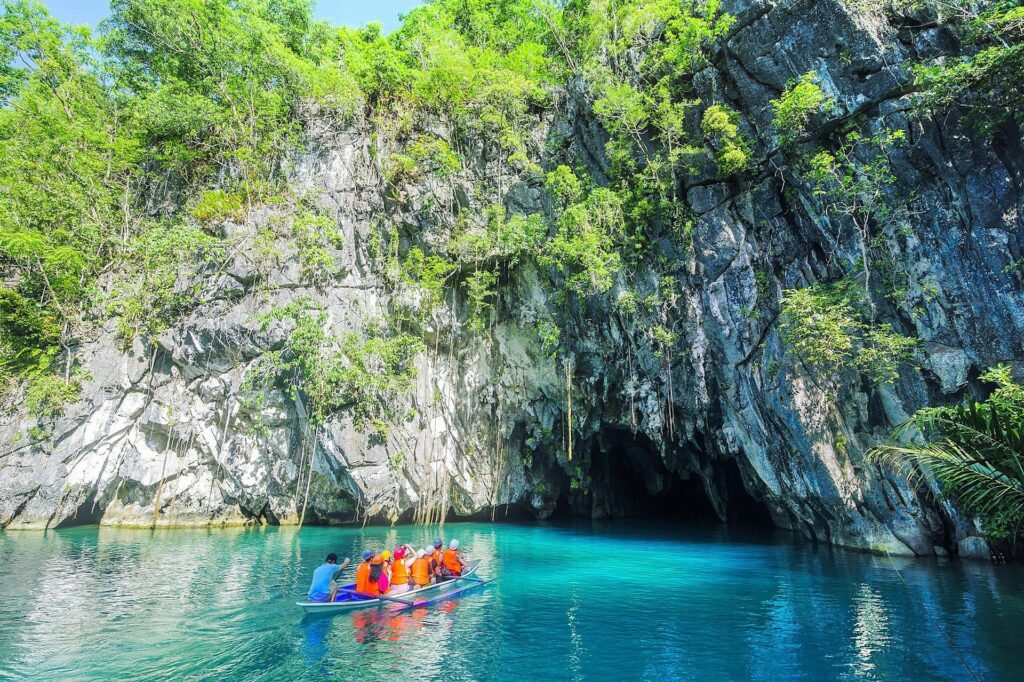 tourists riding a small boat entering the Puerto Princesa Subterranean River in Puerto Princesa Palawan Philippines