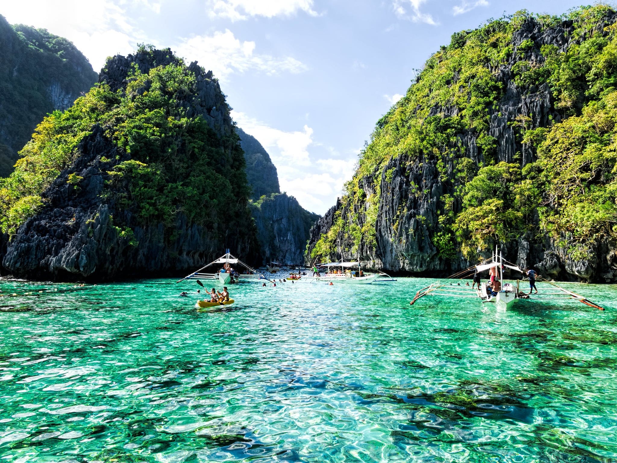 tourists kayaking in Big Lagoon in El Nido Palawan Philippines