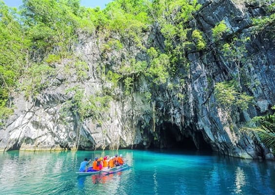 Tourists on a boat approaching the Puerto Princesa Underground River in Palawan